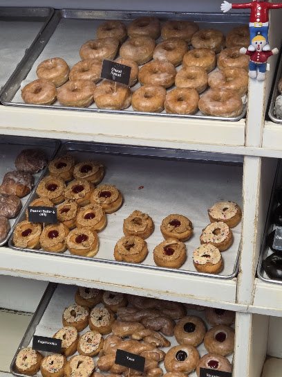 Trays of fresh donuts in the case at Mr Bill's